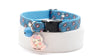 Cat collar with blue paw pattern and bell on a white background