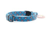 Dog collar with paw print pattern on a blue background