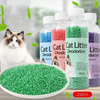 Cat litter deodorizer bottles with a cat and green beads on a blurred background