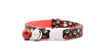 Cat collar with colorful paw print pattern on a white background